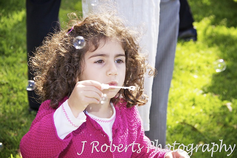 Little girl blowing bubbles - wedding photography sydney